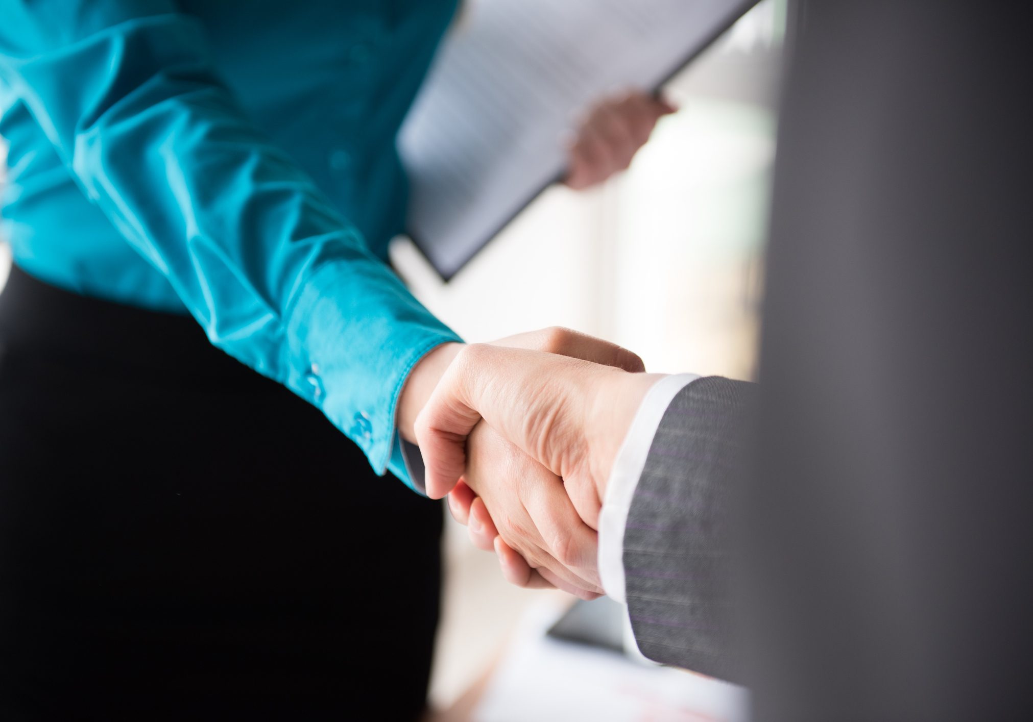 Two business women shaking hands, agreement, contract